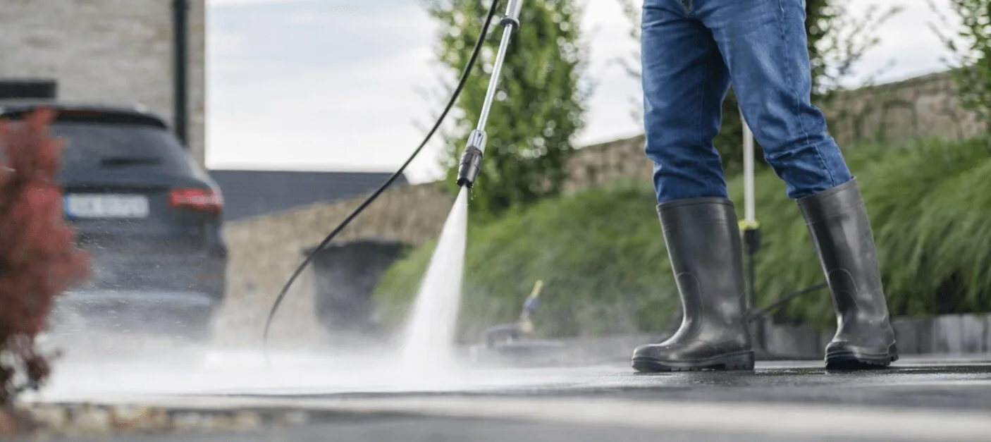 Man Pressure Washing Driveway Wide Angle V3