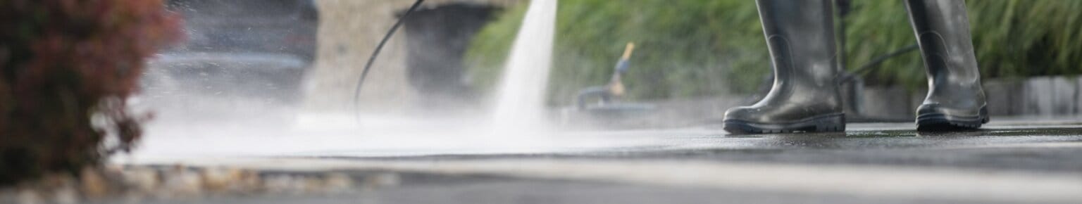 Man Pressure Washing Driveway Wide Angle V5